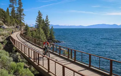 a person riding a bike on a bridge over the water at Mountain Getaway - Lake Tahoe - Incline Village - Private Garage in Incline Village