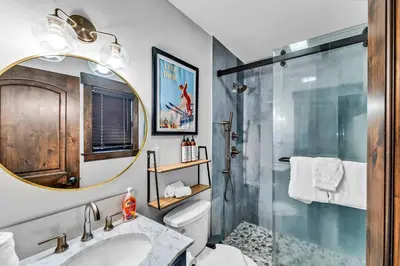 a bathroom with a shower and a sink and a mirror at Fire & Ice Spacious Retreat with Hot tub and Fireplace in Truckee