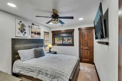 a bedroom with a bed and a ceiling fan at Fire & Ice Spacious Retreat with Hot tub and Fireplace in Truckee