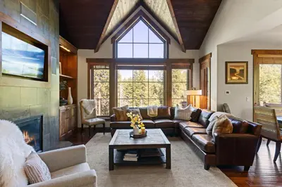 a living room with a couch and a fireplace at Luxury Home Walk to Ski Lifts 6 Pools Food Private Hot-Tub Yard Fun Bunk Room in Truckee