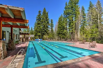 a swimming pool with a house and trees at Luxury Home Walk to Ski Lifts 6 Pools Food Private Hot-Tub Yard Fun Bunk Room in Truckee