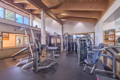 a gym with treadmills and elliptical machines at Luxury Home Walk to Ski Lifts 6 Pools Food Private Hot-Tub Yard Fun Bunk Room in Truckee