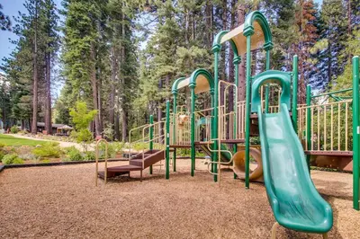 a playground with a slide in a park at Luxury Home Walk to Ski Lifts 6 Pools Food Private Hot-Tub Yard Fun Bunk Room in Truckee