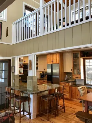 a large kitchen with a large island with wooden chairs at Lake Front-Near Yosemite-Pool Table-Private Dock -PML in Groveland