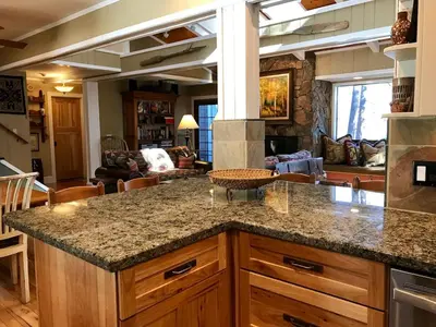 a kitchen with a counter top and a living room at Lake Front-Near Yosemite-Pool Table-Private Dock -PML in Groveland