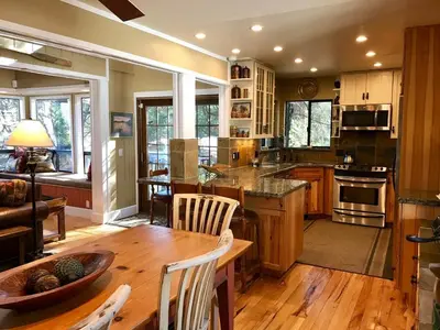 a kitchen with a table and chairs in a room at Lake Front-Near Yosemite-Pool Table-Private Dock -PML in Groveland