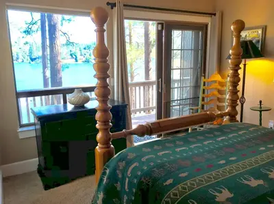 a bedroom with a bed and a large window at Lake Front-Near Yosemite-Pool Table-Private Dock -PML in Groveland