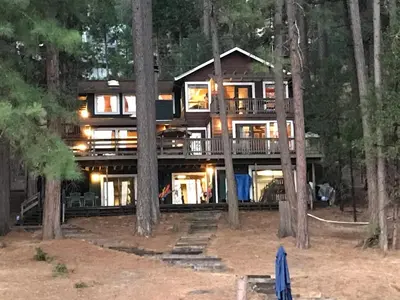 a large house in the middle of the forest at Lake Front-Near Yosemite-Pool Table-Private Dock -PML in Groveland