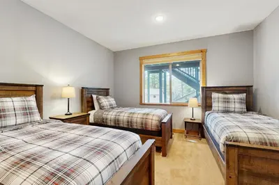 a bedroom with two beds and a window at The Tahoe Timber House in South Lake Tahoe