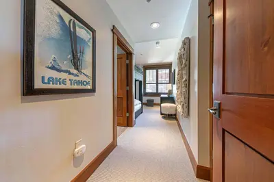 a hallway with a door leading to a living room at Iron Horse Lodge South 302 by East West Hospitality in Truckee
