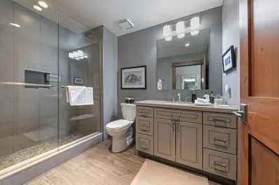 a bathroom with a shower and a toilet and a sink at Iron Horse Lodge South 302 by East West Hospitality in Truckee