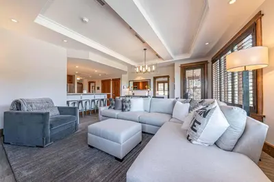 a living room with couches and a kitchen at Iron Horse Lodge South 302 by East West Hospitality in Truckee