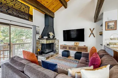 a living room with a couch and a fireplace at Lake Tahoe Adventure Base! Townhome with Pool Access in Wood Vista