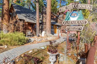 a log cabin with a sign in front of it at Lake Tahoe Adventure Base! Townhome with Pool Access in Wood Vista