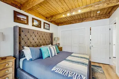 a bedroom with a bed and a wooden ceiling at Lake Tahoe Adventure Base! Townhome with Pool Access in Wood Vista