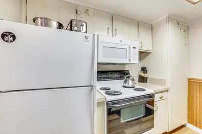 a kitchen with white appliances and a refrigerator at Walk to Shops and Eats Mammoth Lakes Condo with Pool in Mammoth Lakes