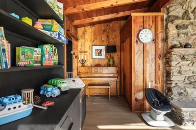 a kitchen with a stove and a clock on the wall at Modern 2 Bedrm Kids, Dog, Hot Tb, Game Room, 9 min Bass Lake in Oakhurst