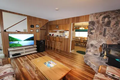 a living room with a large television and a table at HCC0612 - Sitzmark Ski Condo townhouse in South Lake Tahoe