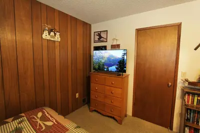 a bedroom with a tv and a dresser with a bed at HCC0612 - Sitzmark Ski Condo townhouse in South Lake Tahoe