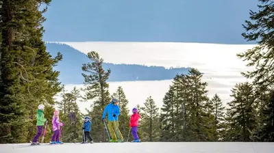 a group of people on skis in the snow at Spacious 5BDR Lake View Home w Hot Tub Close to Slopes Town Beach in Tahoe City