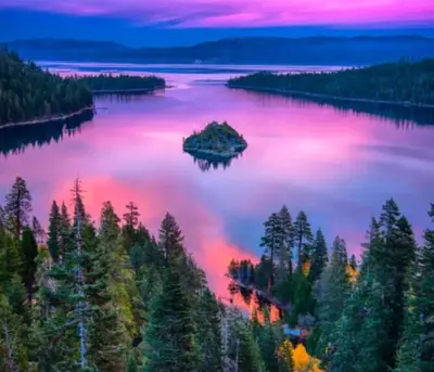 an island in the middle of a lake at sunset at Spacious 5BDR Lake View Home w Hot Tub Close to Slopes Town Beach in Tahoe City