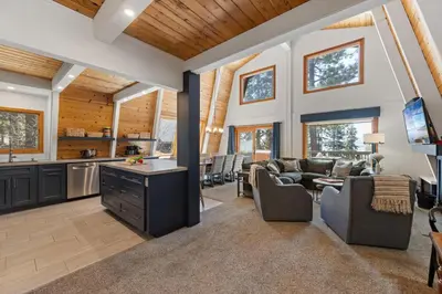 a large living room with a kitchen and a living room at Spacious 5BDR Lake View Home w Hot Tub Close to Slopes Town Beach in Tahoe City