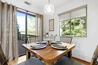 a dining room with a wooden table and chairs at Inspiring Cottage Rental for a Vacation in California Wine Country in Lockeford