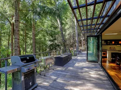 an outdoor deck with a grill and a grill at Stunning and Secluded Lakeside Getaway in the Grass Valley of California in Grass Valley