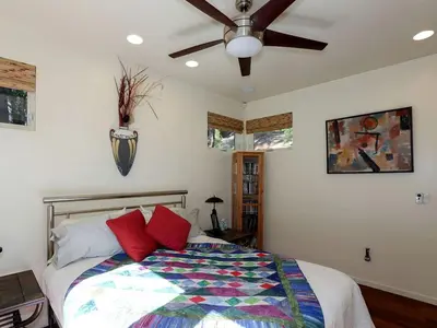a bedroom with a bed with a ceiling fan at Stunning and Secluded Lakeside Getaway in the Grass Valley of California in Grass Valley