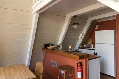 a kitchen with a counter and a white refrigerator at Stunning A-Frame Cabin Rental for Four Guests in Arnold, California in Arnold