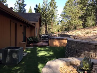 a backyard of a house with a grass yard at Luxury Cabin Rental with a Fire Pit in Coulterville, California in Coulterville