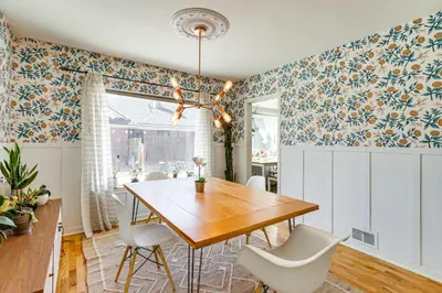 a dining room with a wooden table and white chairs at 24 Mi to Slopes! Family Reno Home with Outdoor Oasis in Reno