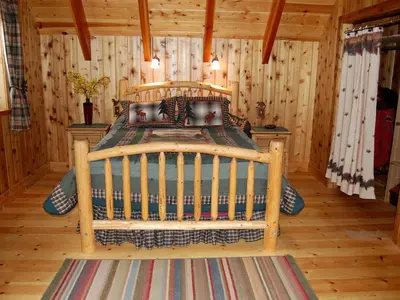 a bedroom with a wooden bed in a cabin at Traditional Log Cabin Rental for Couples on the West Shore of Lake Tahoe, California in Tahoe City