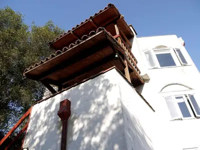 a white building with a roof on top of it at Captivating Riverfront Vacation Rental for Large Groups in Three Rivers, California in Three Rivers