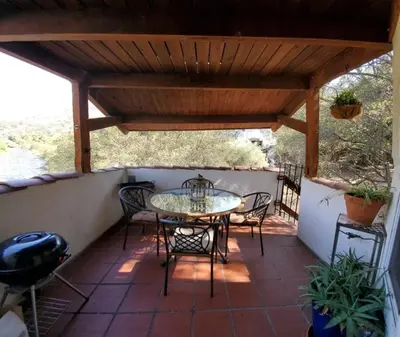 a patio with a table and chairs on a porch at Captivating Riverfront Vacation Rental for Large Groups in Three Rivers, California in Three Rivers