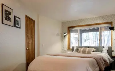 a bedroom with a large bed with a window at Secluded Dome Rental Surrounded by Stunning Nature near Arnold, California in Arnold