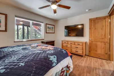 a bedroom with a bed and a dresser and a ceiling fan at Near Downhill Ski Resort! Hot Tub Haven in Truckee in Truckee