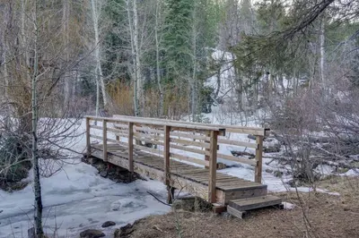 a wooden bridge in a snow covered forest at Near Downhill Ski Resort! Hot Tub Haven in Truckee in Truckee