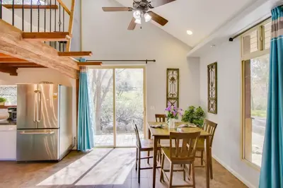 a kitchen and dining room with a table and a refrigerator at Walk to Riverfront Beach Kernville Escape in Kernville