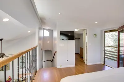 a room with a staircase with a tv on the wall at Walk to Riverfront Beach Kernville Escape in Kernville