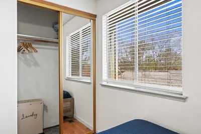 a bedroom with a mirror and a window with a view at Cozy 3BR Family Home with Patio & BBQ grill Close to Casinos and Shops in Reno