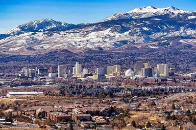 a city with snow capped mountains in the background at Cozy 3BR Family Home with Patio & BBQ grill Close to Casinos and Shops in Reno