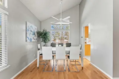 a dining room with a table and white chairs at Cozy 3BR Family Home with Patio & BBQ grill Close to Casinos and Shops in Reno
