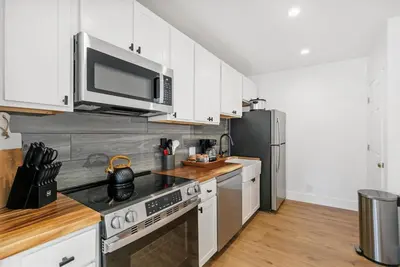a kitchen with white cabinets and a stainless steel refrigerator at Experience Zephyr Cove Retreat Relax Enjoy #6 in Zephyr Cove