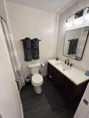 a bathroom with a toilet and a sink and a mirror at First level studio Unit #7 close to everything bike, ski, swim Zephyr Cove! in Zephyr Cove