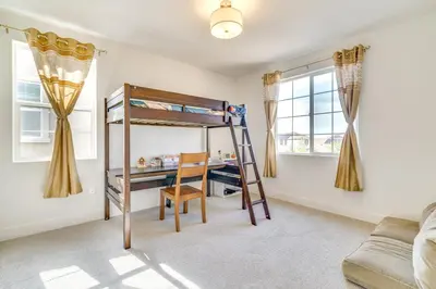 a bedroom with a bunk bed and a desk at Pool Paradise Spacious Tracy Home with Yard! in Tracy