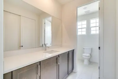 a bathroom with a sink and a toilet at Pool Paradise Spacious Tracy Home with Yard! in Tracy