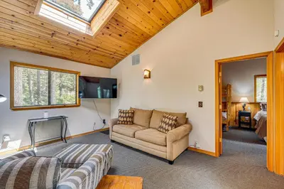 a living room with a couch and a window at Game Room Blue Lake Mountain Retreat in Arnold in Arnold