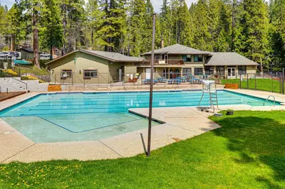 a swimming pool in front of a house at Game Room Blue Lake Mountain Retreat in Arnold in Arnold