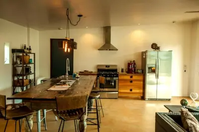 a kitchen with a large wooden table and a refrigerator at Stunning Lone Pine Accommodation for Romantic Getaways in California in Lone Pine